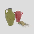 Green and Red Ceramic Vessels with Handles Displayed with Soap Bars and Open Book