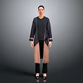 Woman In Dark Long Coat With Black Inner Top Pants And Shoes On Gray Background