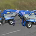 Two Blue New Holland Combine Harvesters Parked on Green Farm Grassland Road