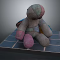 Patchwork Fabric Doll With Various Colors Sitting On Blue Tiled Platform