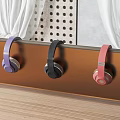Colorful Headphones Hanging On Brown Shelf With Curtains Perforated Wall And Wooden Floor