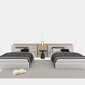 Two Single Beds In Bedroom With Nightstand Lamp Pillows Blanket On Rug And Open Book