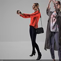 Woman Taking Selfie In Red Long Sleeve Top With Dark Pants Black Boots And Handbag