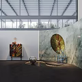Modern Art Exhibition Space Featuring Large Circular Artwork Colorful Painting Sculptures And Metal Grid Ceiling