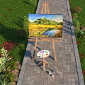 Art Supplies Easel With Scenic Landscape Painting Near Green Plants And Stones Under Blue Sky