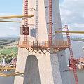 Massive Cable Stayed Bridge Under Construction With Tower Crane Spanning The Wide Calm River