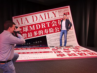 Person Posing At Giant AIA DAILY Newspaper Display For Global MDRT Life Insurance Company 3d model