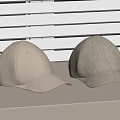 Two Beige Baseball Caps With Different Textures On Light Colored Surface And White Blinds Background