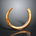 Golden Circular Metal Sculpture With Shiny Surface And Curved Design Details