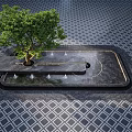Outdoor Water Fountain Design With Central Tree And Diamond Patterned Floor Surrounded By Geometric Paving