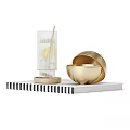 Decorative Ornament Set With Transparent Glass Cup Wooden Base And Golden Bowls On Magazine