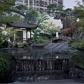 Rockery Stones With Waterfall And Pond In Traditional Garden Featuring Pavilion And Green Plants