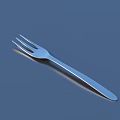 Modern Cutlery Set Featuring Shiny Stainless Steel Fork On Blue Surface
