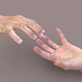 Woman's gentle hands reaching out softly towards each other on gray background
