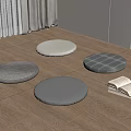 Round Floor Cushions In Various Colors With Stack Of Books On Wooden Floor
