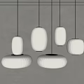 Modern White Pendant Lights In Different Sizes With Round Shades Hanging Over Interior Space