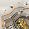 Modern Staircase With Wooden Handrail And Glass Railings Framed Pictures And Yellow Flowers