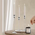 Elegant Decorative Ornament Set With Silver Candle Holders White Candles And Lit Match