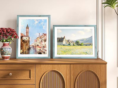 Two Blue Picture Frames With Scenic Paintings On Wooden Cabinet And Red Flower Vase 3d model