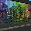 Stunning Water Fountain With Colorful Lighted Water Curtain Reflecting Trees And Buildings In Evening
