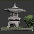 Traditional Stone Lantern With Carved Details And Green Bush On Grass Base