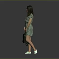 A Woman In Green Floral Dress Holding Green Bag With White Shoes Against Gray Background