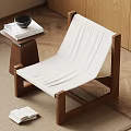 Modern Wooden Frame Accent Chair with White Upholstery Side Table and Books on Wooden Floor