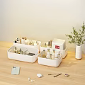Organized Perfumes And Cosmetics In White Storage Boxes On Wooden Tabletop