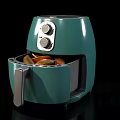 Green Air Fryer With Open Drawer Containing Fried Food And Control Knobs
