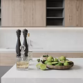 Elegant Kitchen Countertop With Black Pepper Grinders Glass Oil Bottle And Wooden Lime Bowl