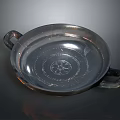 Metal Dish With Two Handles And Central Carved Sculpture Design