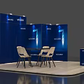 Blue Exhibition Booth With Display Panels Round Table White Chairs And Reception Desk