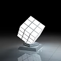 Modern Illuminated Cube Sculpture As Photo Check in Spot With Reflective Floor And Black Background