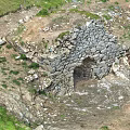 Microtopography Featuring Stone Wall Structure With Arched Entrance And Natural Terrain