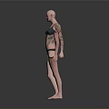 Bald Woman Wearing Green Bikini With Arm Tattoo on Reflective Floor Against Gray Background