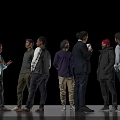 Group of Men Standing Together Casually Talking and Holding a Cup