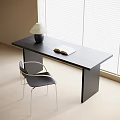 Modern Black Desk With Open Book Table Lamp And Black Metal Chair By Window
