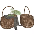 Two Handwoven Wicker Storage Baskets With Gray Fabric And Green Foliage