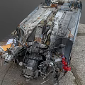 Dismantled Car Wreckage With Scattered Rusted Metal Parts On Ground