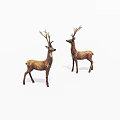 Two Decorative Deer Figurines With Antlers Standing As Ornamental Statues