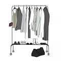 Hanging Clothes on Metal Rack with Shoes and Black Bag
