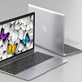 Open Silver Laptop With Colorful Butterflies And White Pebbles Screen Display Alongside Closed Laptop