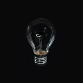 Clear Transparent Glass Light Bulb on Black Background with Visible Filament