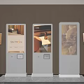 Multiple White Vertical Digital Signage Kiosks With Display Stands Showing Images In Commercial Space