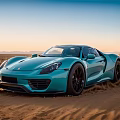Blue Porsche Sports Car Driving Through Desert With Dust And Sunset Mountains