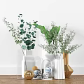 Modern White and Transparent Vases with Green Plants and Golden Decor