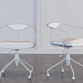 Two Modern Office Chairs with Black Armrests Padded Seats and Swivel Bases