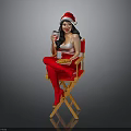 Woman In Santa Hat On Director's Chair With Red Stockings Holding Drink And Food Plate