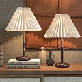 Pleated Table Lamps With Wooden Bases On Cabinet Featuring Vogue Books Decor And Leather Wall