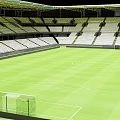 Modern Football Stadium With Green Pitch White Tiered Seats And Goalposts